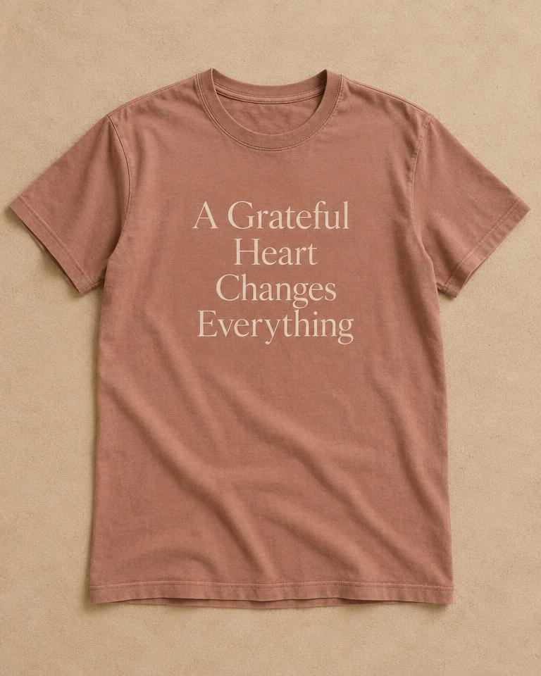Clay-colored t-shirt printed with A Grateful Heart Changes Everything